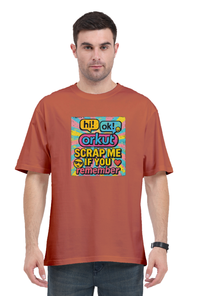 Man wearing a rust orange Orkut Oversized T-Shirt with colorful retro graphic and text on front