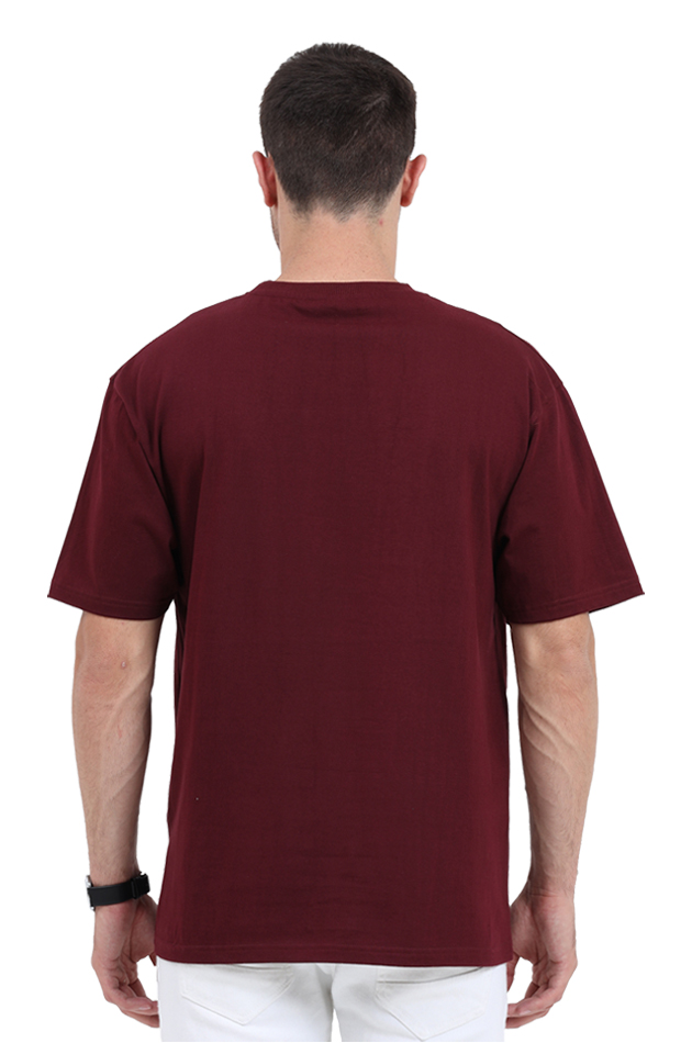 Back view of a man wearing a plain maroon Y2K Orkut Oversized T-Shirt and white pants